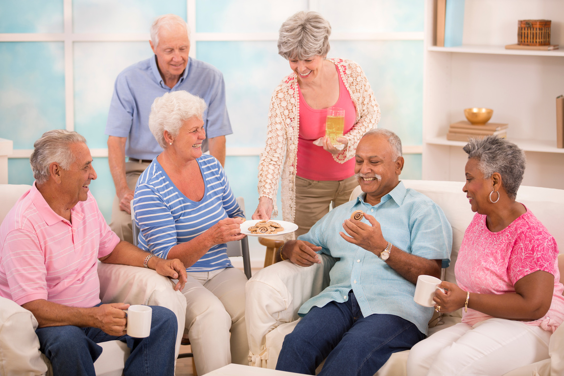 Senior adult friends share news, friendship.  Home or assisted living.
